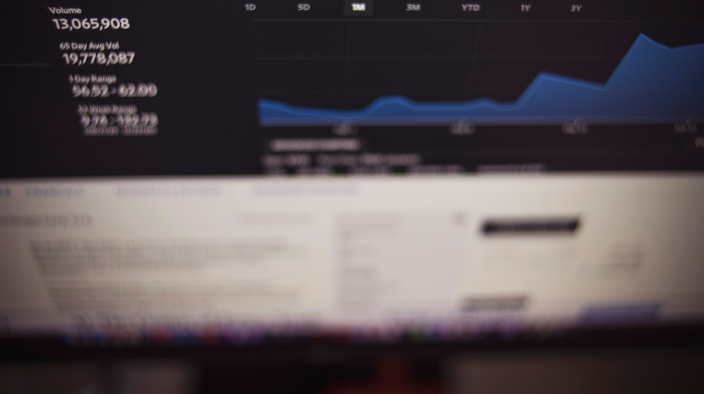 Computer screen showing stock market data and a blue line graph.